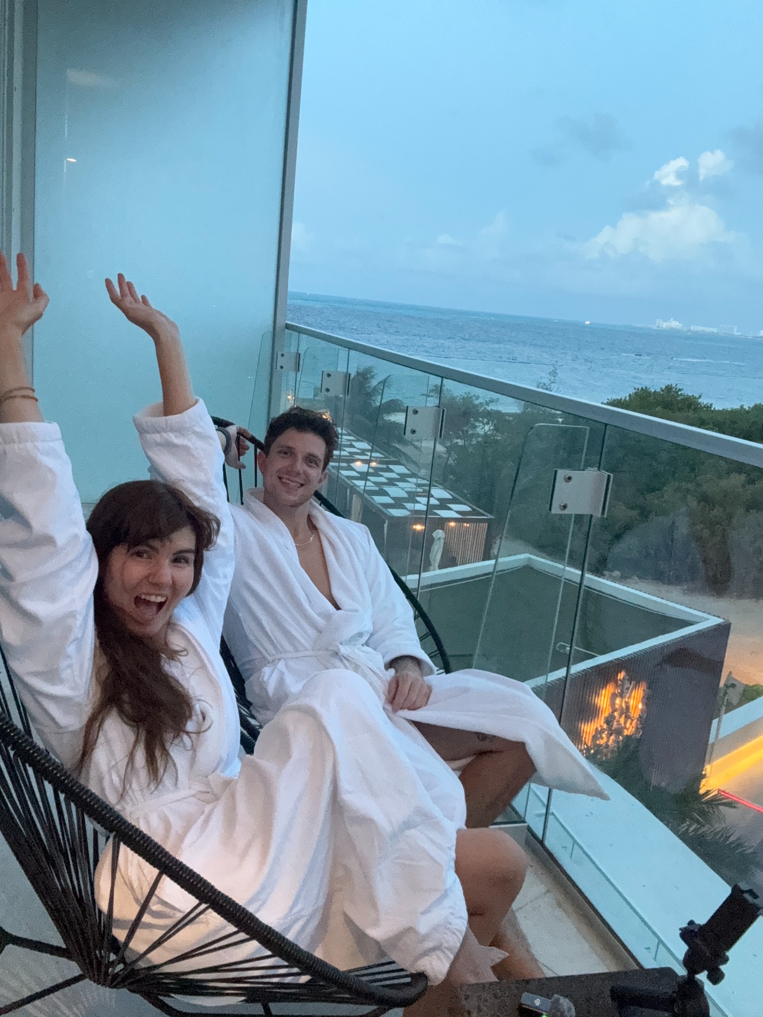 Cassie and Christian enjoying a resort balcony overlooking the sea
