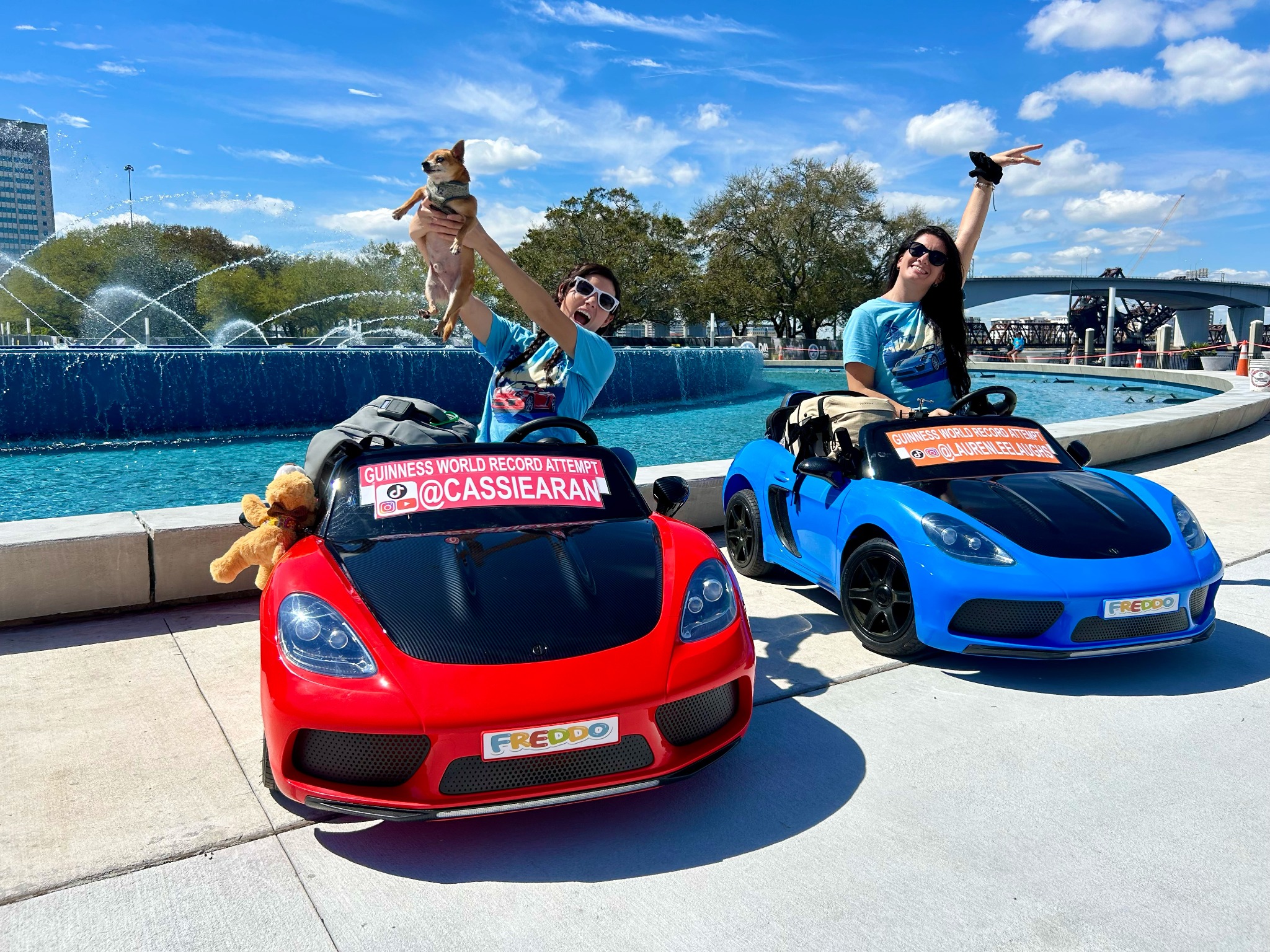 Cassie and Lauren laughing together with their toy car collection